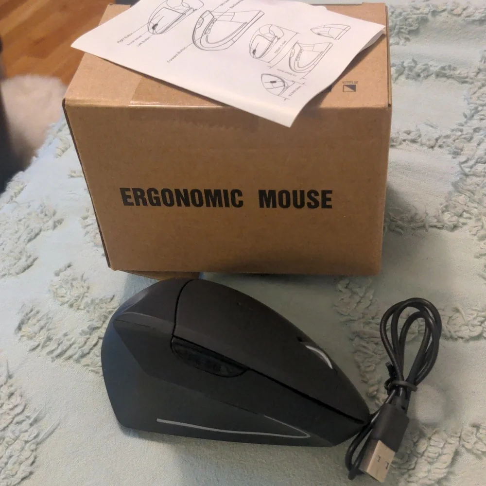 Ergonomic wireless mouse with charging cable. New in box